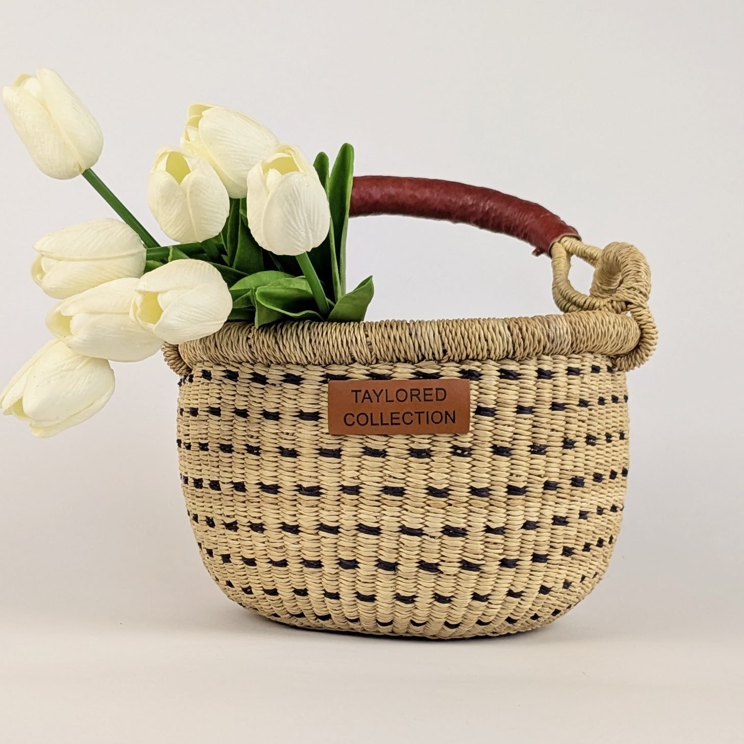 Small round gathering basket with a leather wrapped handle
