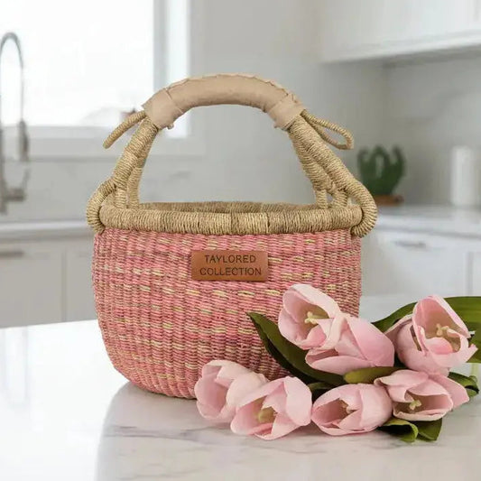 Small Pink Bolga Basket sitting on a white kitchen Counter