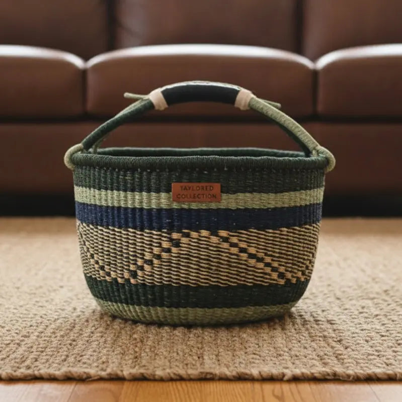woven basket with stripes and a geometric pattern facing forward with a leather logo label
