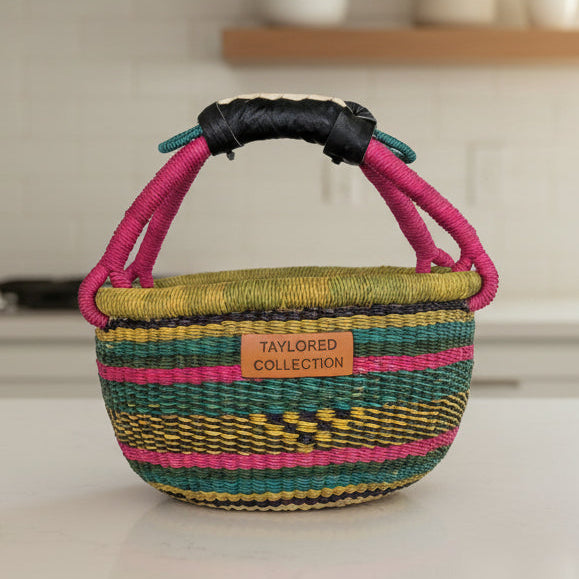 Colorful woven basket with pink handles on a kitchen counter