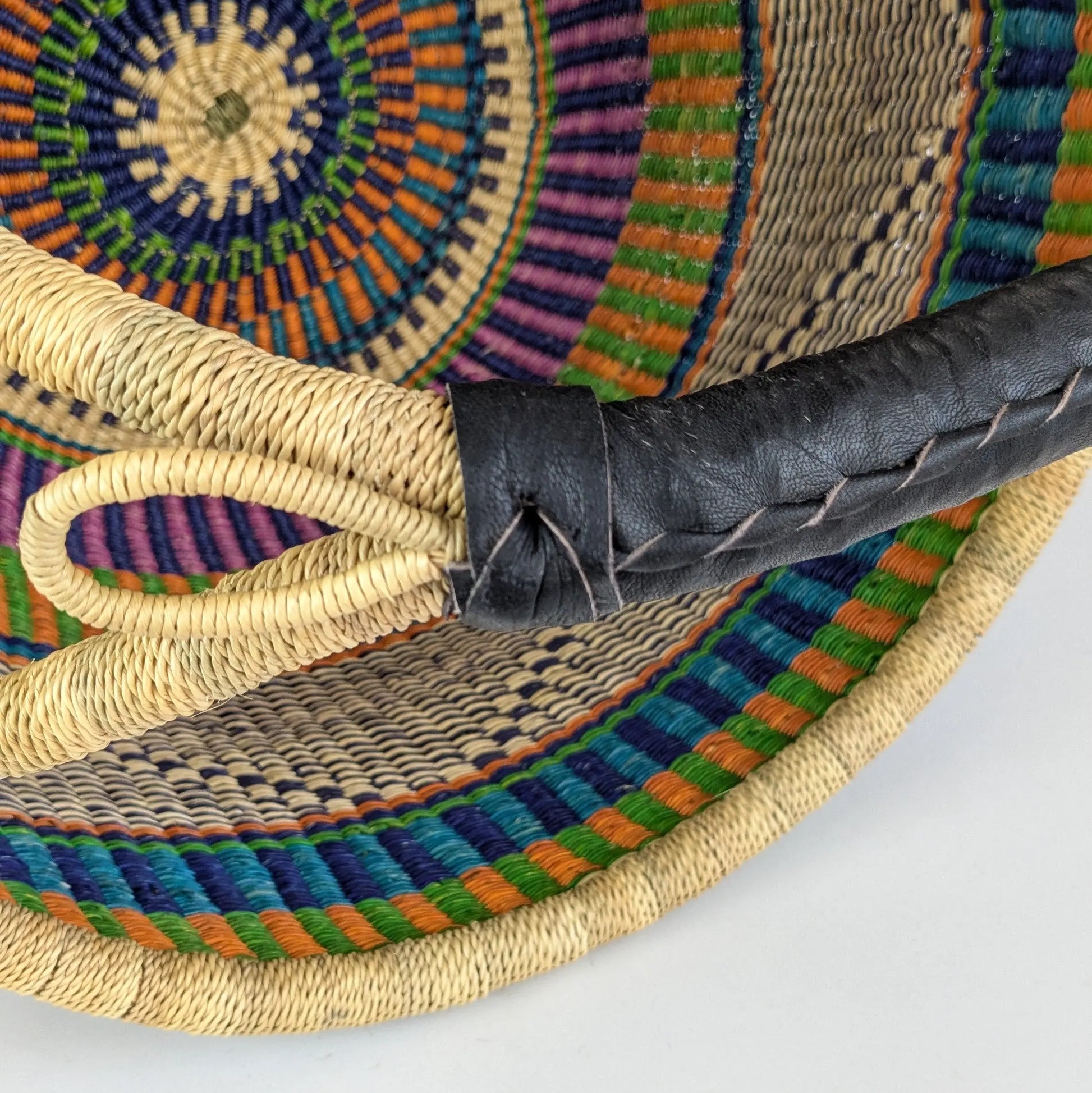 Close-up of a woven chair with colorful patterns on a white background