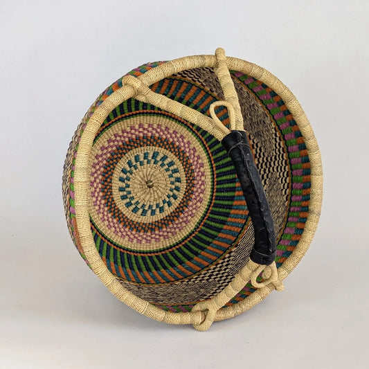 Woven basket with colorful patterns on a light gray background